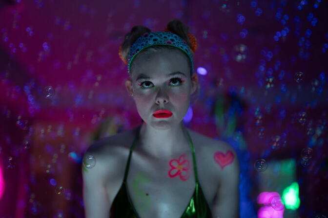 A photo from a TV show featuring a young woman in a club-like setting.