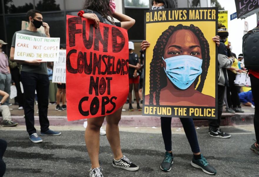 LOS ANGELES, CALIFORNIA - JUNE 23: Black Lives Matter-Los Angeles supporters protest outside the Unified School District headquarters calling on the board of education to defund school police on June 23, 2020 in Los Angeles, California. The demonstrators want the funds currently spent on campus police to be reallocated to other student-serving priorities.  (Photo by Mario Tama/Getty Images)