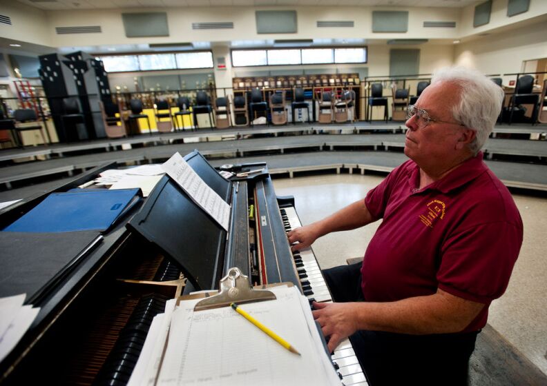 Vocal music teacher Tony Azeltine plays piano in one of the new music classrooms at Mark Keppel High School.