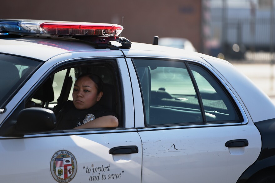 A police officer patrols Skid Row in Los Angeles, California, September 22, 2014.