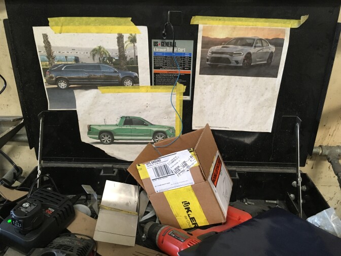 A toolbox with memorable vehicles taped inside for inspiration. 