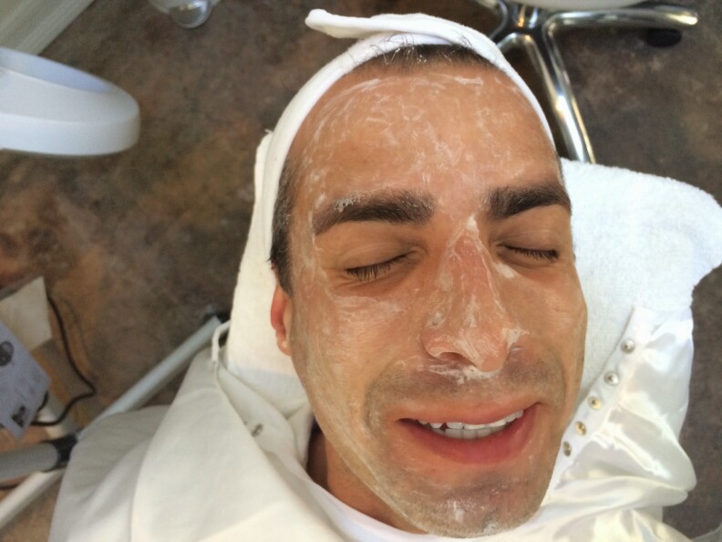 A Martinez getting a facial at FaceHaus while conducting an interview.
