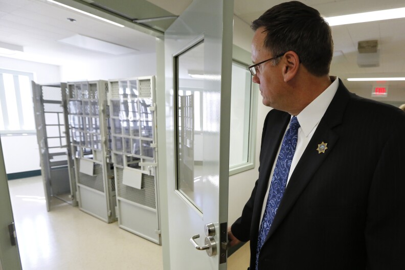 Brian Duffy, acting warden of the California Medical Facility, looks in one of the prison's inmate holding rooms at the newly opened new mental health treatment unit in Vacaville, Calif., Thursday, Feb. 14, 2013.  The  $24 million treatment center for mentally ill inmates opened on Thursday as state corrections officials used the occasion to push for ending federal oversight of that aspect of prison operations. The 44,000-square-foot building includes rooms where inmates will undergo individual, group and recreational outpatient therapy. It will be used to treat inmates who are seriously mentally ill but are able to function without around-the-clock care.