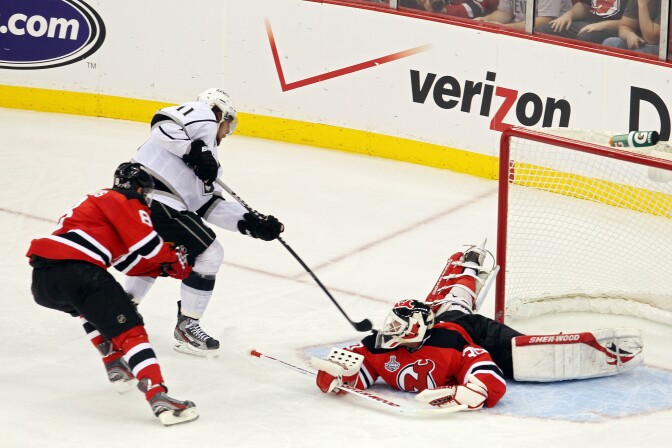 NEWARK, NJ - MAY 30:  Anze Kopitar #11 of the Los Angeles Kings shoots the game winning goal in overtime against Dainius Zubrus #8 and Martin Brodeur #30 of the New Jersey Devils during Game One of the 2012 NHL Stanley Cup Final at the Prudential Center on May 30, 2012 in Newark, New Jersey.  (Photo by Jim McIsaac/Getty Images)