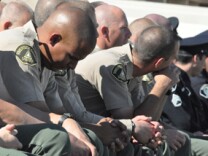Members of the Riverside County Sheriff's Department pay their respects to Riverside Police Officer Ryan Bonaminio on Tuesday, Nov. 16, 2010.