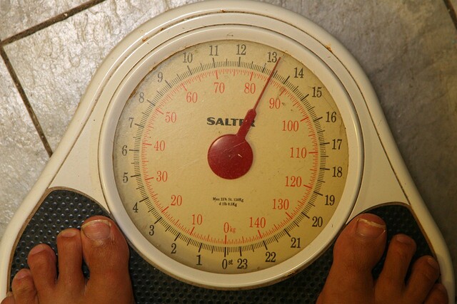 A man stands on a scale. 
