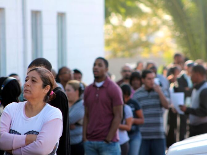 A line of job seekers wait to get into a Walmart hiring event at the Metropolitan Baptist Church in Altadena on Dec. 8, 2012. 