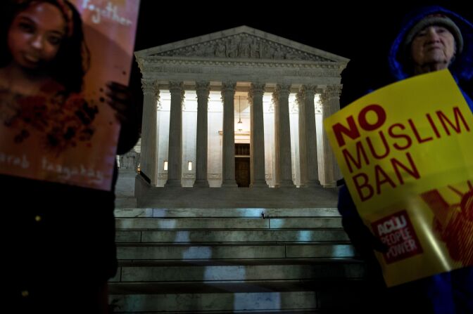 Activists protest the travel ban outside the US Supreme Court December 7, 2017 in Washington, DC.
Three versions of President Donald Trump's travel ban -- the most controversial of his executive orders -- were successfully blocked by the courts, before the Supreme Court allowed the third to take affect this week, pending appeals. / AFP PHOTO / Brendan Smialowski        (Photo credit should read BRENDAN SMIALOWSKI/AFP/Getty Images)