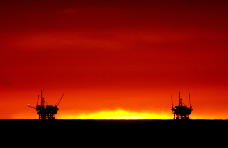 385757 03: The sun fades from view as it sets between the Hillhouse A, left, and Hillhouse B oil and gas platforms near the Federal Ecological Reserve in the Santa Barbara Channel, February 15, 2001, near Santa Barbara, CA. In recent months the state Coastal Commission has argued against the federal government in its lawsuit over offshore oil exploration, a case that could lead to more drilling near a marine sanctuary or leave up to 1 billion barrels of oil untapped. The tourism-heavy area relies on its coast to attract visitors and has been sensitive to oil drilling since a 3.3 million gallon spill from a platform in 1969 spawned an anti-drilling movement. (Photo by David McNew/Newsmakers)

