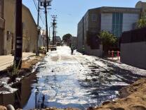 Crude oil being cleaned up on Brazil Street after an oil spill in Atwater Village on Thursday, May 15, 2014.