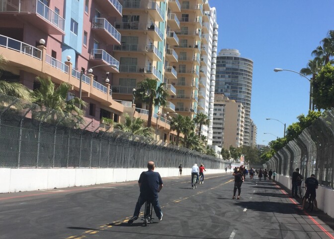 Tommy Kendall speeds off on his scooter to enjoy a lap on the Gran Prix track. 