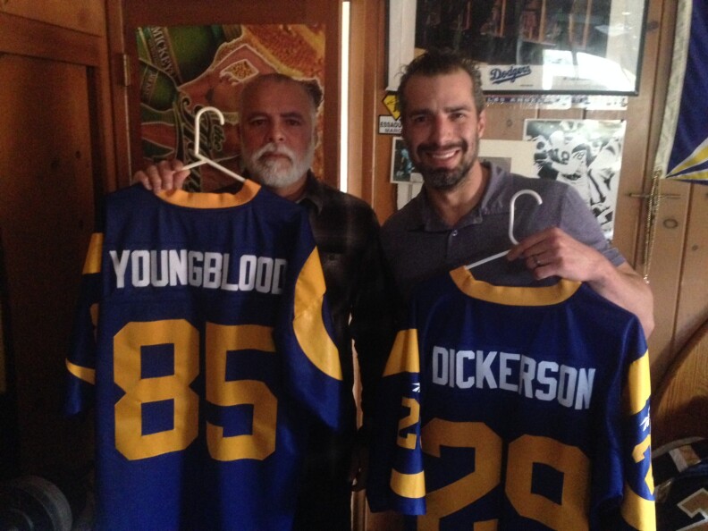 Ernie Garcia and A Martinez posing with two of his favorite jerseys ... 