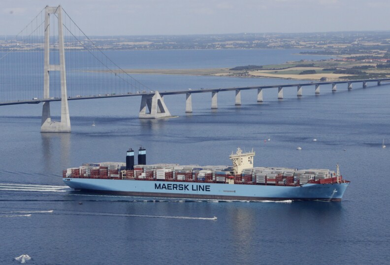 The world's largest container ship, the Maersk Mc-Kinney Moller, which was built in Busan, South Korea, by Danish shipping company Maersk line, and is named after the late ship owner passes the Storebaelts Bridge, Denmark, on the last kilometer of it's maiden voyage, Tuesday Aug. 20, 2013. (AP Photo/Polfoto, Per Rasmussen) DENMARK OUT