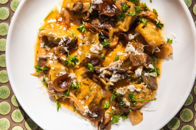 Lamb angiolotti in a creamy tomato sauce on a white bowl.