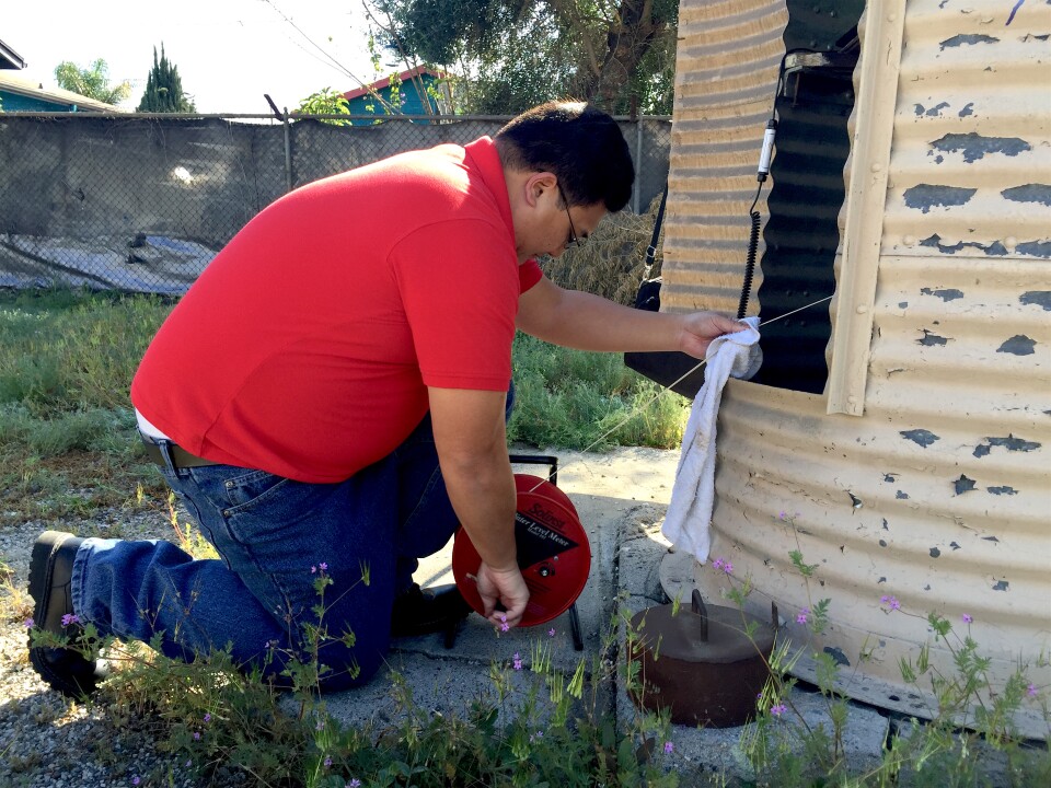 Tuan Nguyen checks the groundwater level at the Main San Gabriel Basin's "key well" in Baldwin Park, CA.