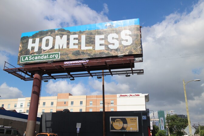 This billboard at the corner of Vine St. and Santa Monica Blvd. in Hollywood, is one of more than a dozen that went up around Los Angeles over the weekend. Out on the street, the real Hollywood can be seen in the distant.