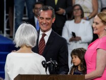 Sukey Roth, Mayor Eric Garcetti's mother administers the oath of office for her son at City Hall in Los Angeles, California on July 1, 2017. Mayor Garcetti is accompanied by his wife Amy Wakeland and their daughter, Maya.