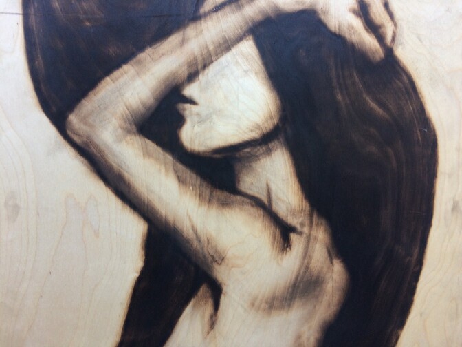 A detail of one of Aronson’s portraits reveals how he incorporates the wood grain of each individual slab into his composition. 