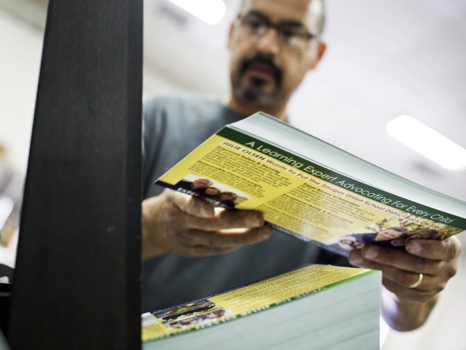 Lucio Sandoval inserts campaign mailers into an address printer at Mellady Direct Marketing in Santa Clarita, Calif. on Thursday morning, Oct. 6, 2016.