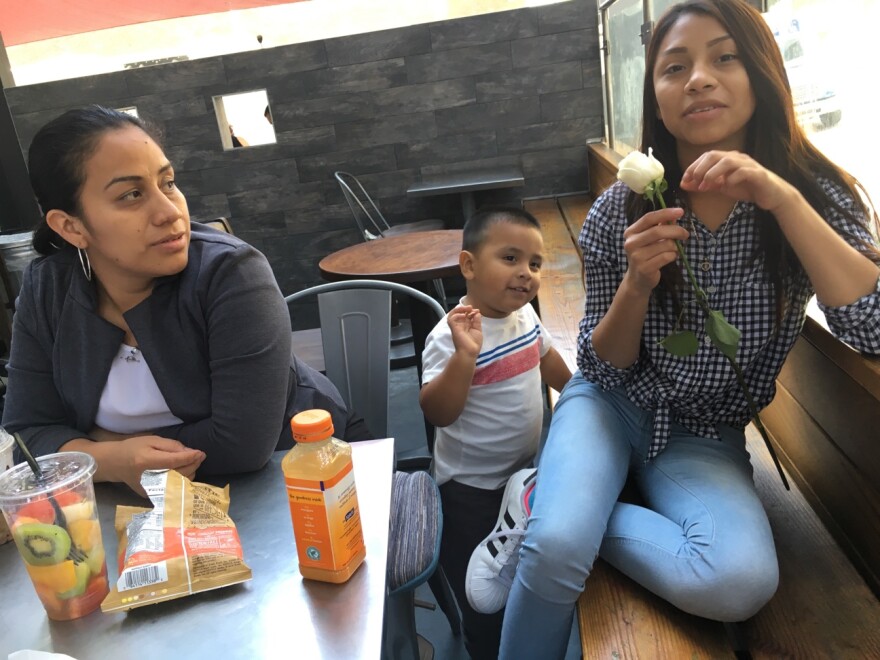 Ana Hernández looks on as her daughter, Michelle, takes a break after her visit to the immigration court in Los Angeles.