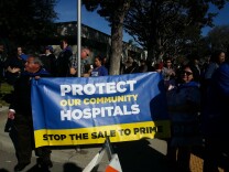 Members of SEIU United Health Workers West opposed to the sale of the Daughters of Charity Hospitals to Prime Healthcare rally outside of Monday's public hearing in Lynwood.