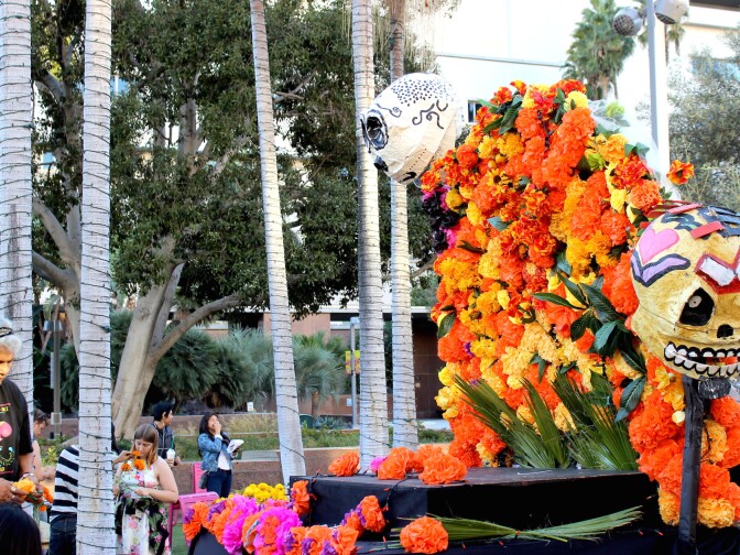 Ofelia Esparza works on her altar at Grand Park.