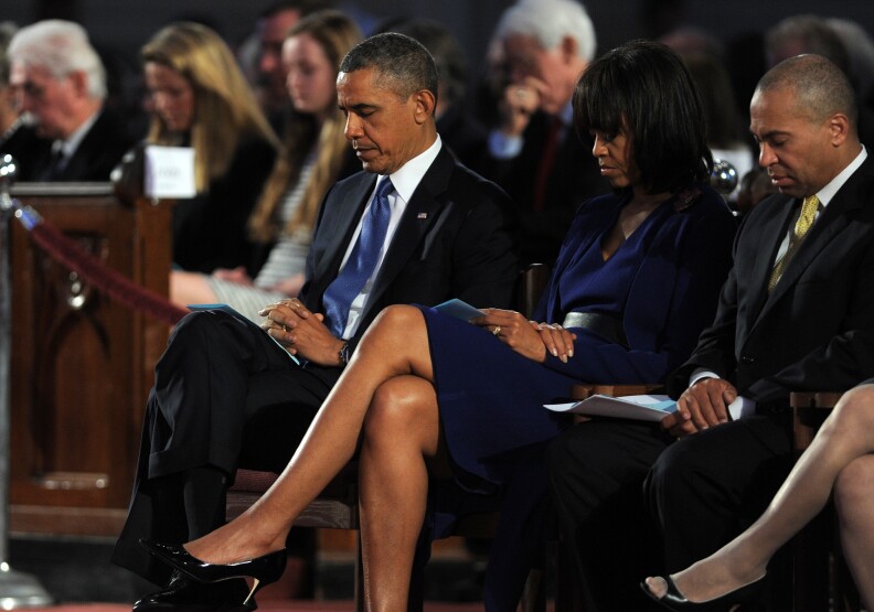 S President Barack Obama and First Lady Michelle Obama (C) attend the 'Healing Our City: An Interfaith Service' dedicated to those who were gravely wounded or killed in the Boston Marathon bombing, at the Cathedral of the Holy Cross in Boston, Massachusetts, on April 18, 2013. Obama mourns victims of the deadly marathon attacks, as investigators study images of a suspect who may have planted the bombs. No arrests have been made in connection with Monday's twin bombings near the finish line of the race, which sent metal fragments and nails into a crowd of thousands of runners and spectators, killing three people and wounding 180. Seated next to Mrs. Obama is Massachussetts Governor Deval L. Patrick. 