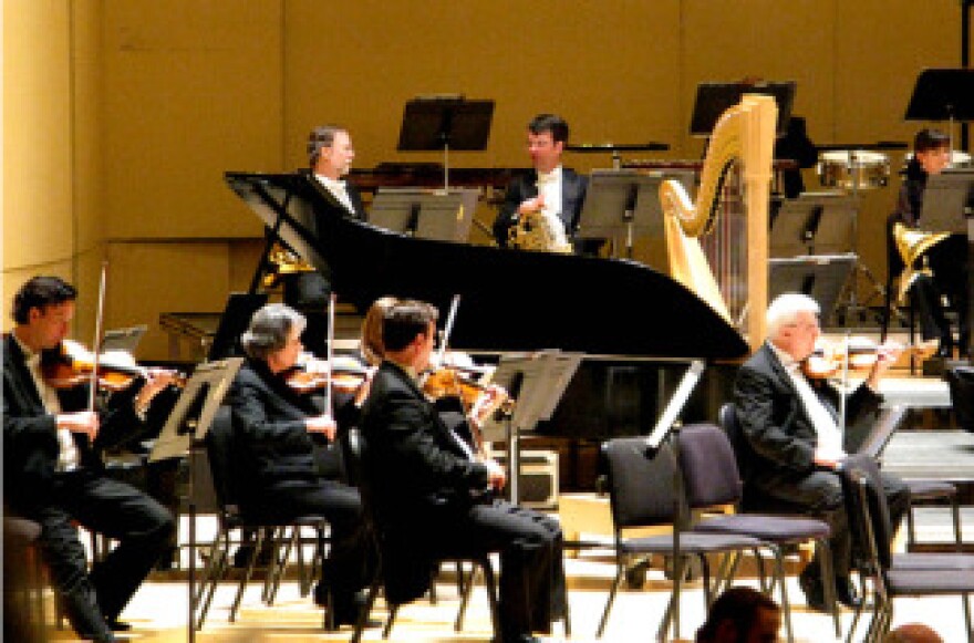Symphony orchestra players warm up before a concert.