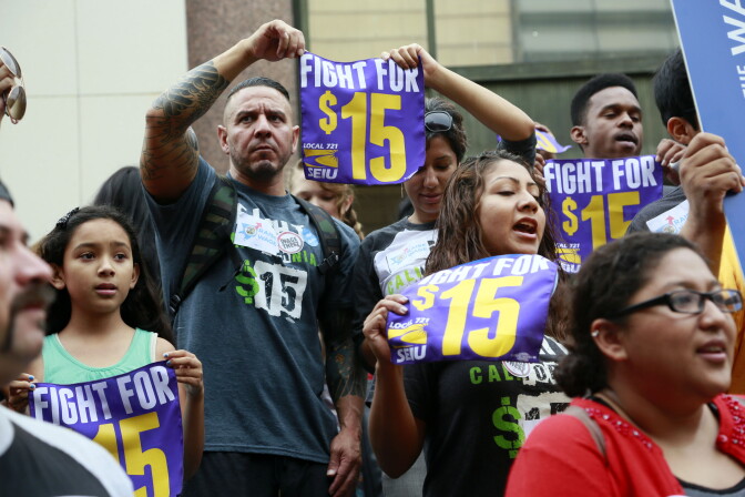 In this July 21, 2015 photo, workers hold a rally in Los Angeles in support of the Los Angeles County Board of Supervisors' proposed minimum wage ordinance. On March 26, California legislators and labor unions reached an agreement that will take the state's minimum wage from $10 to $15 an hour. 