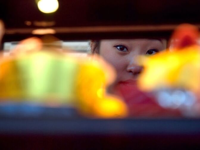 WEST COVINA, Calif. -- Storefront employee Tiffany Chiang of Diamond Bar, Calif., inspects the arrangement of pastries in the dessert case at the new 85°C Bakery Cafe on Jan. 16. This company-owned West Covina location is the third to open in the United States, with more openings planned throughout Southern California. The Taiwan-based chain, while new to the U.S. market, operates more than 700 stores worldwide.