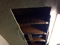The county has struggled to maintain public housing units scattered across southern L.A. Sherrie King says this hole's been in her ceiling for months.