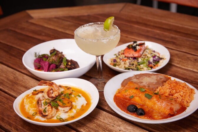 four dishes from a progessive dinner menu surround a margarita