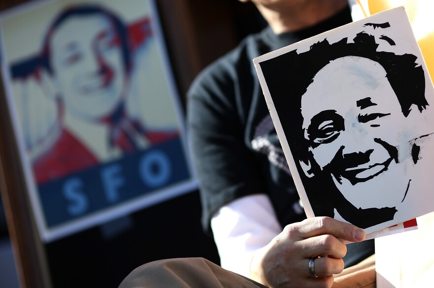 SAN FRANCISCO, CA - FEBRUARY 22:  Supporters hold signs with the image of slain San Francisco supervisor Harvey Milk during a rally at San Francisco City Hall on February 22, 2013 in San Francisco, California.  Dozens of supporters staged a rally in front of San Francisco City Hall to support San Francisco supervisor David Campos's Harvey Milk SFO charter amendment that aims to change the name of the San Francisco International Airport to Harvey Milk SFO in honor of the Milk who was the first openly gay elected official in the United States. Milk was assassinated on November 27, 1978 along with then San Francisco Mayor George Moscone by Dan White, a San Francisco supervisor who had recently resigned.  (Photo by Justin Sullivan/Getty Images)