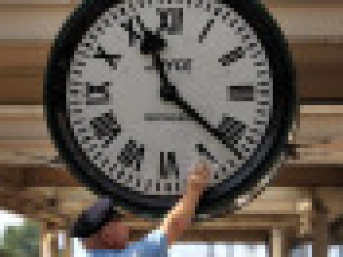 Clock keeper Jim Walker winds up the famous 'Brief Encounter' clock at Carnforth Railway Station on August 3, 2009 in Carnforth, England