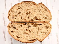 This image shows the interior crumb of a beautifully baked artisan sourdough loaf.