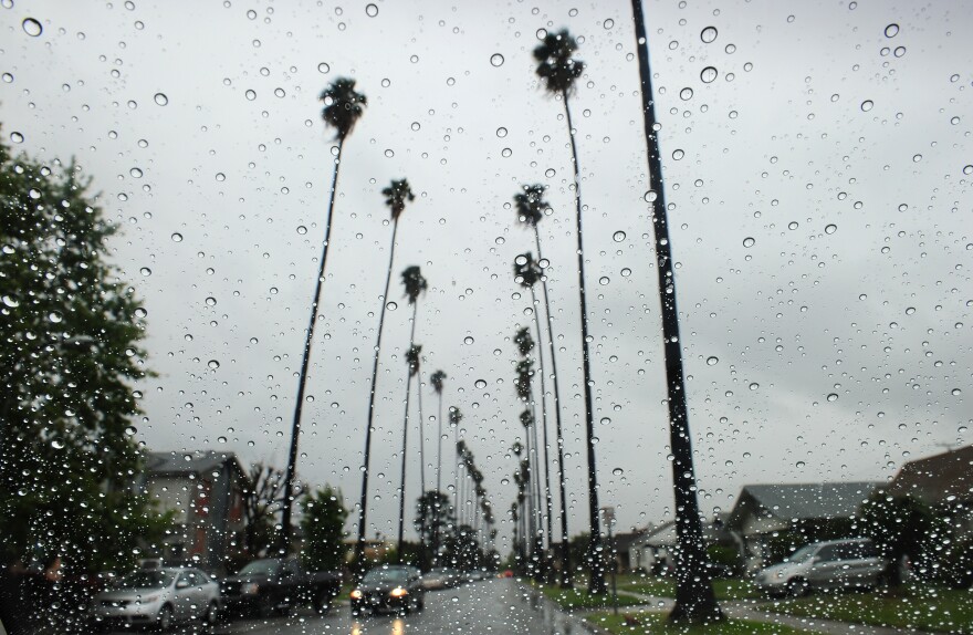 Raindrops are seen on a vehicle's windshield as a car makes its way down a tree-lined street in Alhambra, east of downtown Los Angeles on April 13, 2012 in California.   