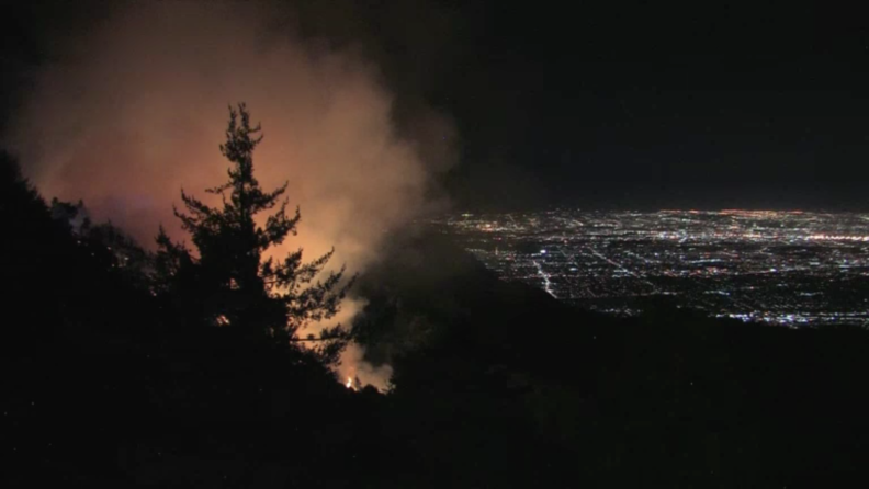 County officials say no structures are immediately threatened by a brush fire that broke out before dawn Tuesday, Oct. 17, 2017, on steep hillsides near the historic observatory on Mt. Wilson above Los Angeles.