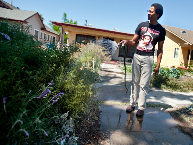 John Parker of Los Angeles waters part of his garden which is in a parkway, a small piece of land next to the curb that is technically owned by the city.