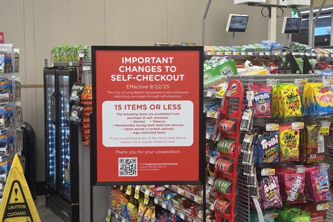 A sign in a supermarket stating "Important changes to self-checkout" followed by a list of rules.