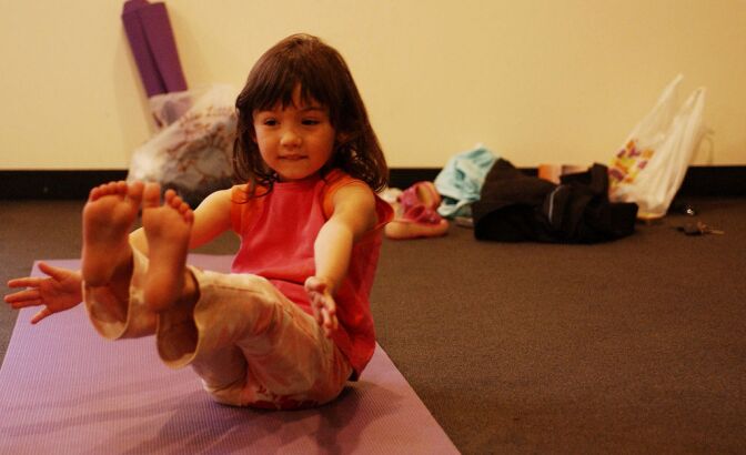SANTA MONICA, CA - APRIL 17: A child poses during Yoga Education for Kids class at the Step Up Women's Network's Third Annual "Step Up For Yoga and Health" charity festival at Bergamont Station, April 17, 2004 in Santa Monica, California. (Photo by Amanda Edwards/Getty Images)