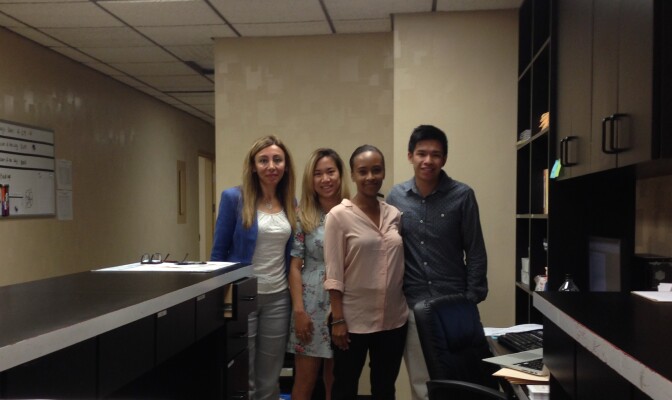 From Left: Bita Ghafoori, Cameron Shibata, Kim Reddy, and Stanley Wong stand in the lobby of their new workplace, the Long Beach Trauma Recovery Center.