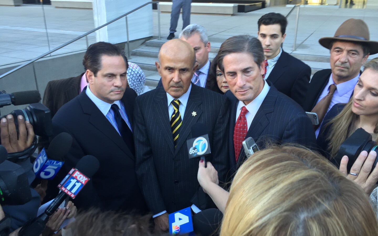 Former Los Angeles County Sheriff Lee Baca (center) and his attorney Nathan Hochman (right) outside federal court in Los Angeles after a judge declared a mistrial in the obstruction of justice case against Baca. He's now being retried. 