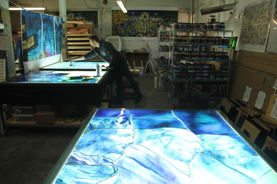 In the basement of the Judson Studios, artist Tim Carey is using the fusing technique. 