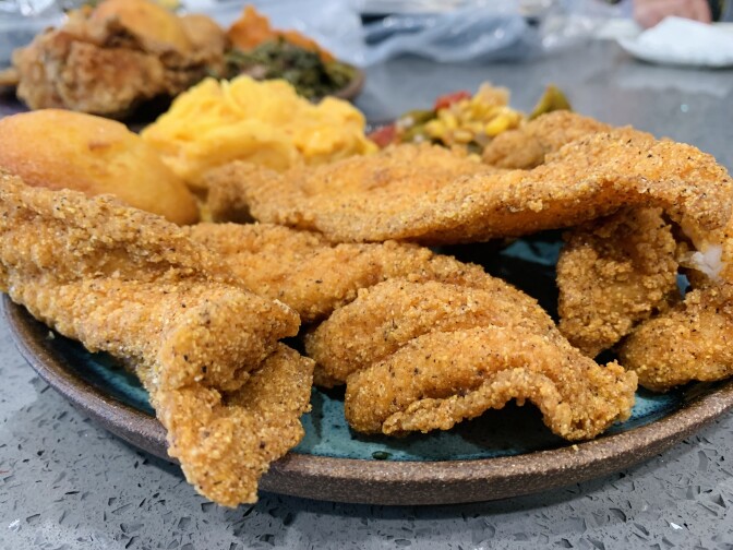 The fried chicken and the fried fish dinner with an assortment of sides (collard greens, corn and okra salad, candied sweet potatoes, macaroni and cheese and cornbread muffins) from Dulan's Soul Food Kitchen at Manchester and La Brea.