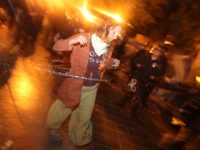 An Occupy Los Angeles hula hooped in the plaza as she was surrounded by police officers in riot gear.
