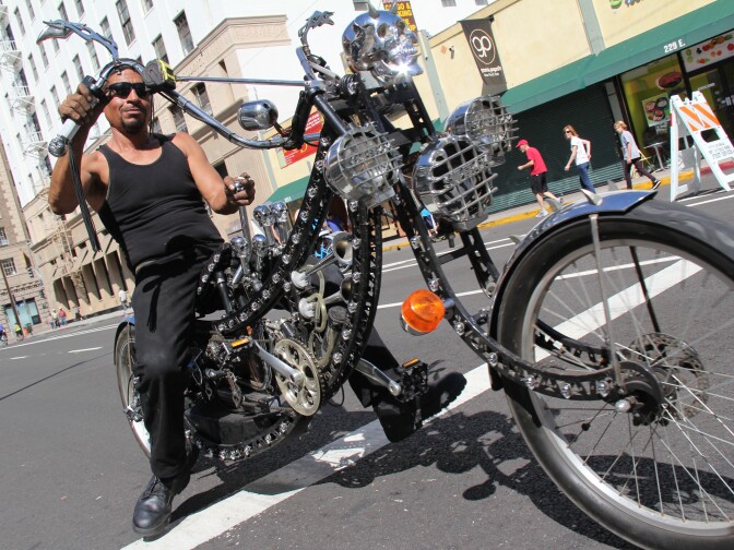 Art "Chopper" Ramirez rides down 9th Street on his customized bike at L.A.'s third CicLAvia event on October 9, 2011.