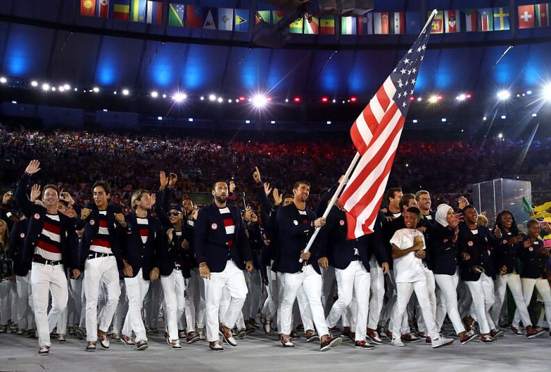 Michael Phelps of the United States carries the flag during the Opening Ceremony of the Rio 2016 Olympic Games at Maracana Stadium on August 5, 2016 in Rio de Janeiro, Brazil.