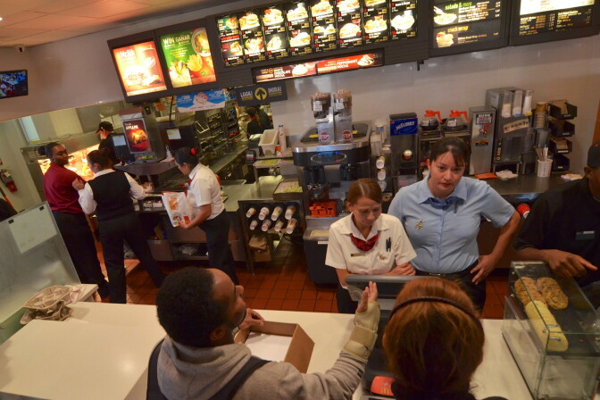 Protesters attempt to give the manager of the Melrose and Vermont McDonald's petitions from MoveOn.org the day before national protests asking fast food restaurants to pay their workers a living wage.