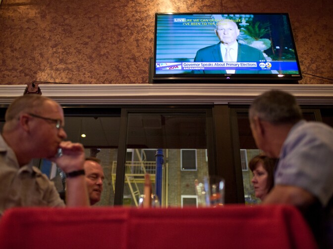 A press conference with Governor Jerry Brown is televised during an election gathering for Los Angeles County Sheriff candidate Bob Olmsted at Pierre Garden in Glendale on Tuesday night, June 3.
