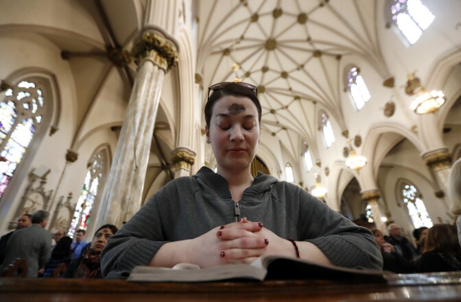 A woman prays after receiving the ashes during an Ash Wednesday service at St. Patrick's Pro-Cathedral, Wednesday, March 1, 2017, in Newark, N.J. (AP Photo/Julio Cortez)
